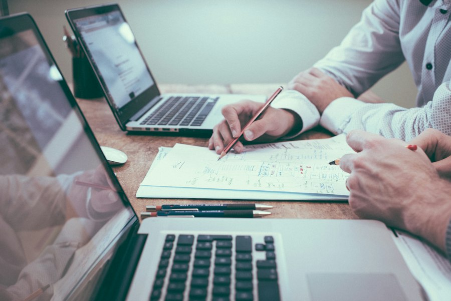 Person reviewing documents and charts on a desk