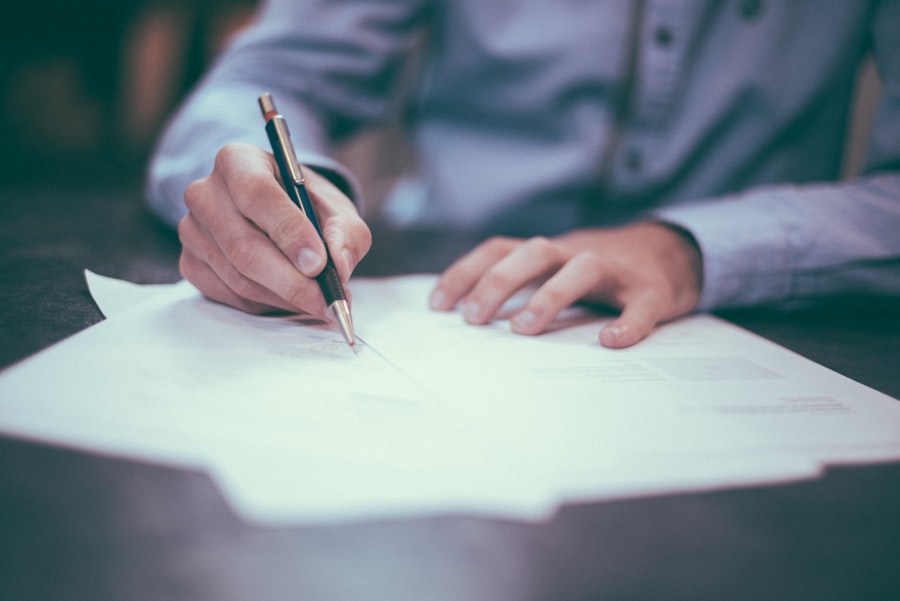 Signing an approval form at a desk